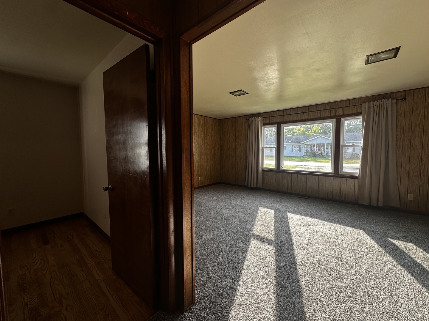 213 North Peoria Street Gilman, IL 60938 - Photo 15 of 44 a view of an empty room with a window and wooden floor