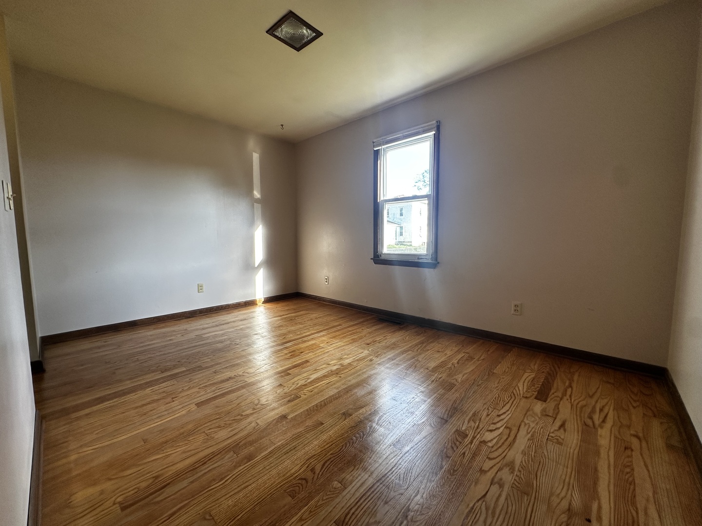 213 North Peoria Street Gilman, IL 60938 - Photo 18 of 44 an empty room with wooden floor and windows
