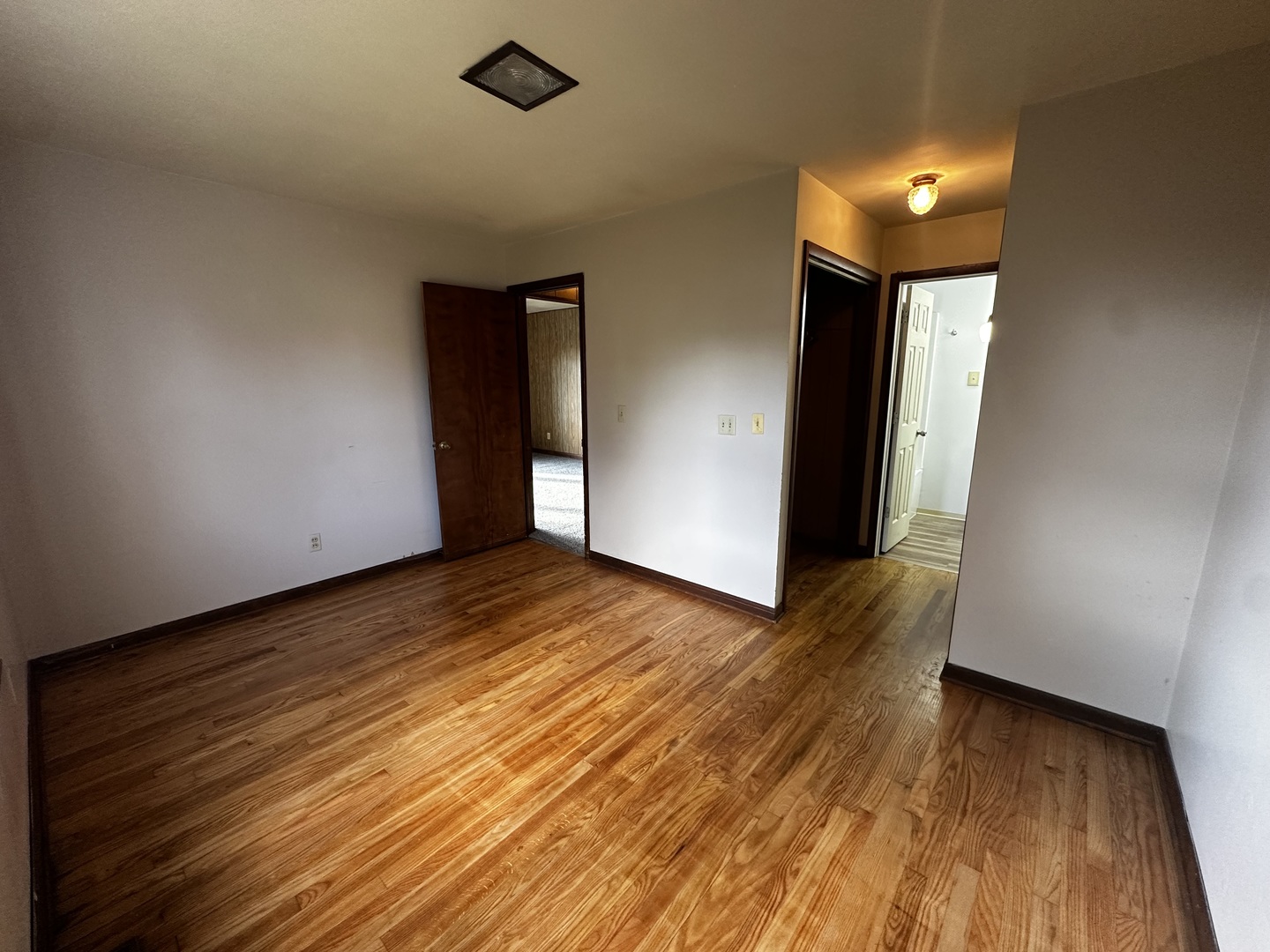 213 North Peoria Street Gilman, IL 60938 - Photo 19 of 44 wooden floor in an empty room with a window