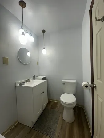 a bathroom with a toilet sink and a mirror