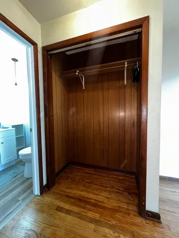 a view of a room with wooden floor and bathroom