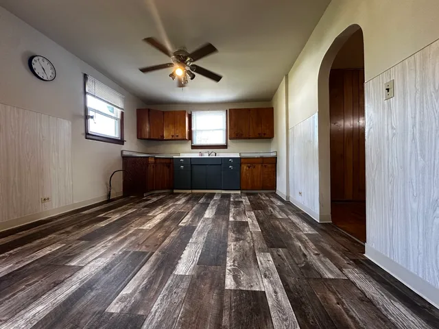 a large kitchen with kitchen island granite countertop a refrigerator stove top oven and sink