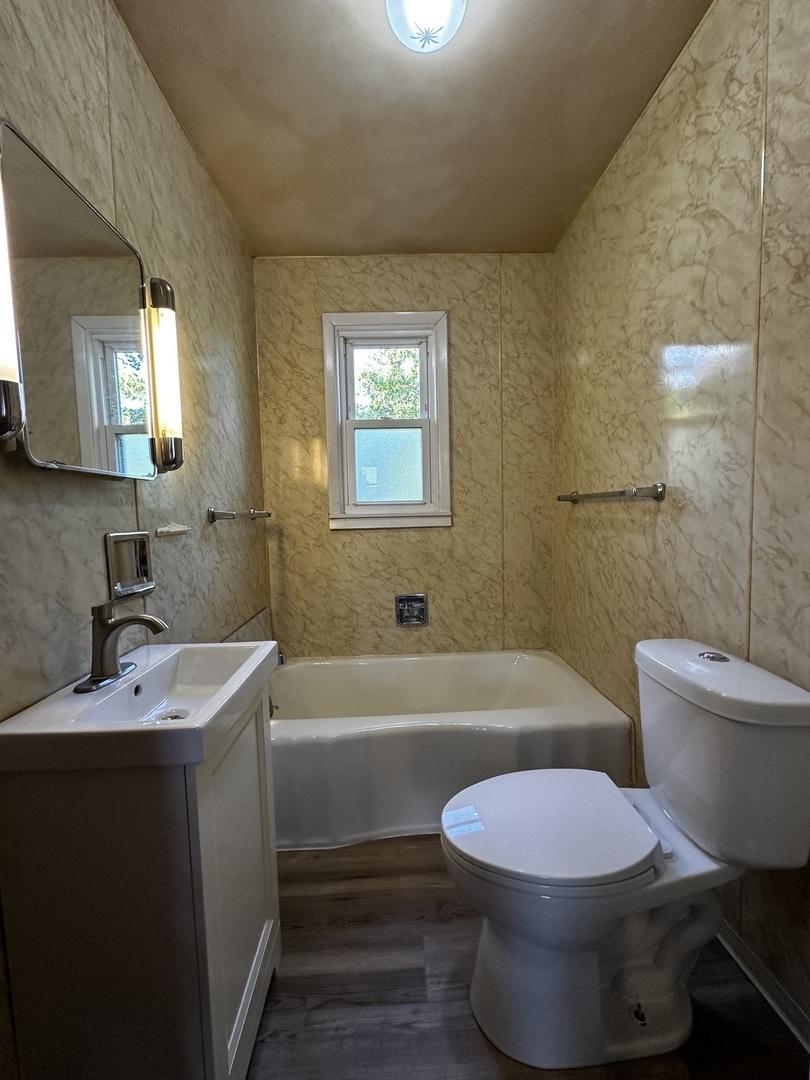 213 North Peoria Street Gilman, IL 60938 - Photo 26 of 44 a bathroom with a sink a toilet a bathtub and a shower