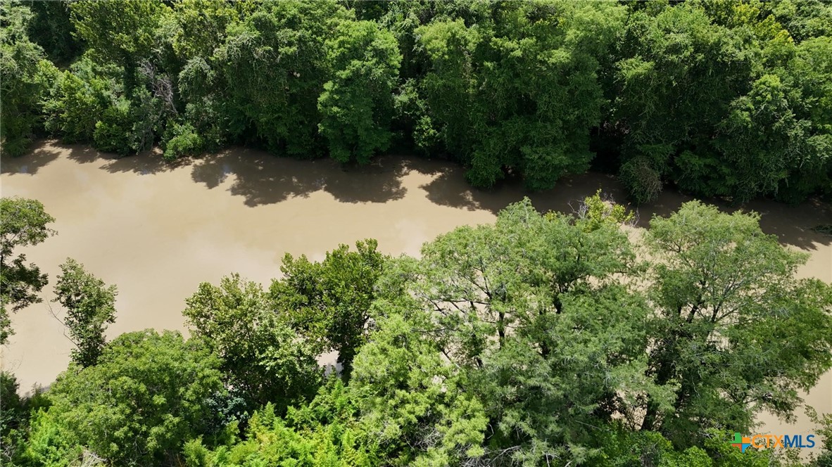 340 Cypress Valley Road Cuero, TX 77954 - Photo 15 of 23 a view of a lake with a yard