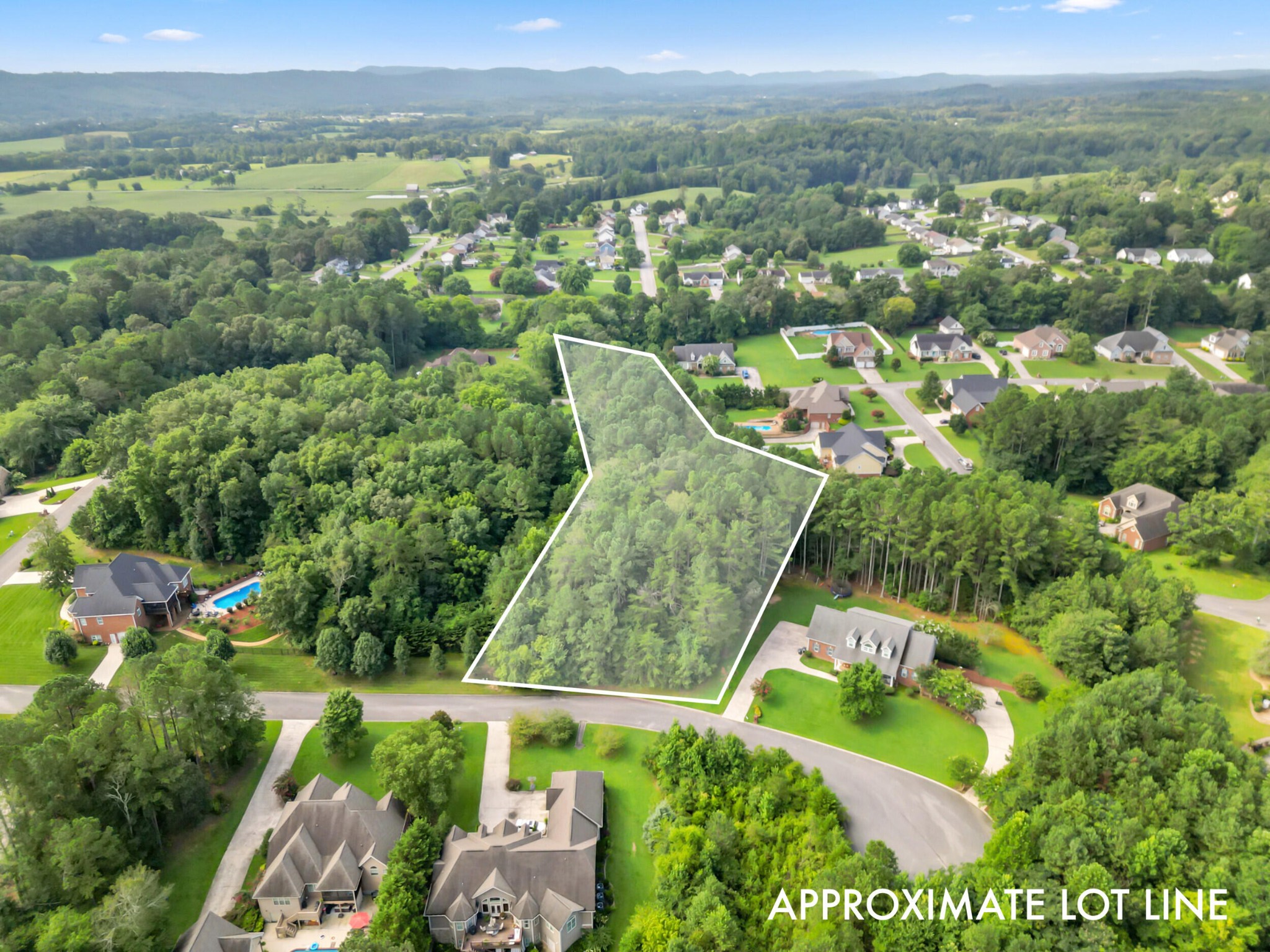 an aerial view of a residential houses with outdoor space and street view