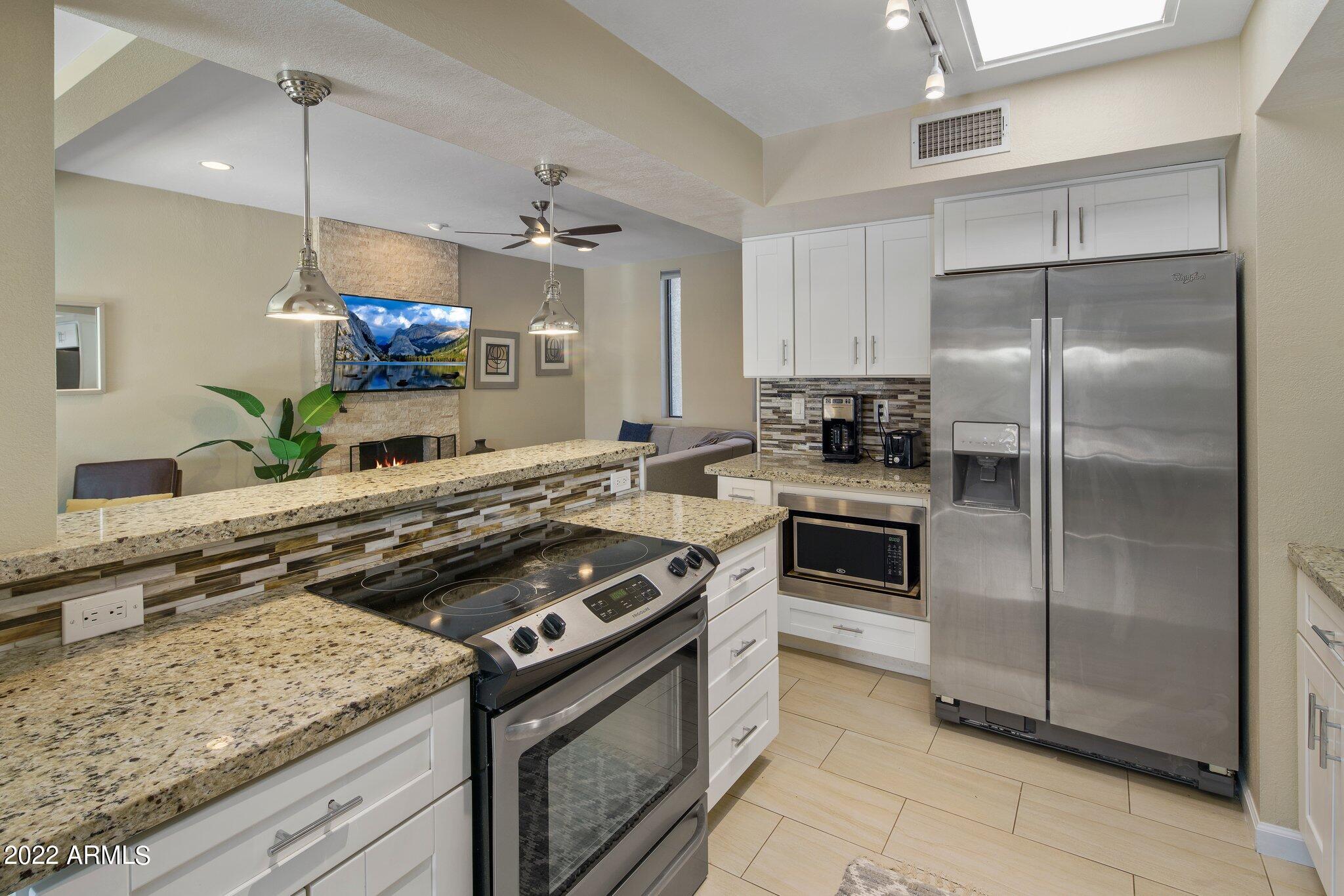 6609 East Phelps Road Scottsdale, AZ 85254 - Photo 43 of 83 a kitchen with a stove and a refrigerator