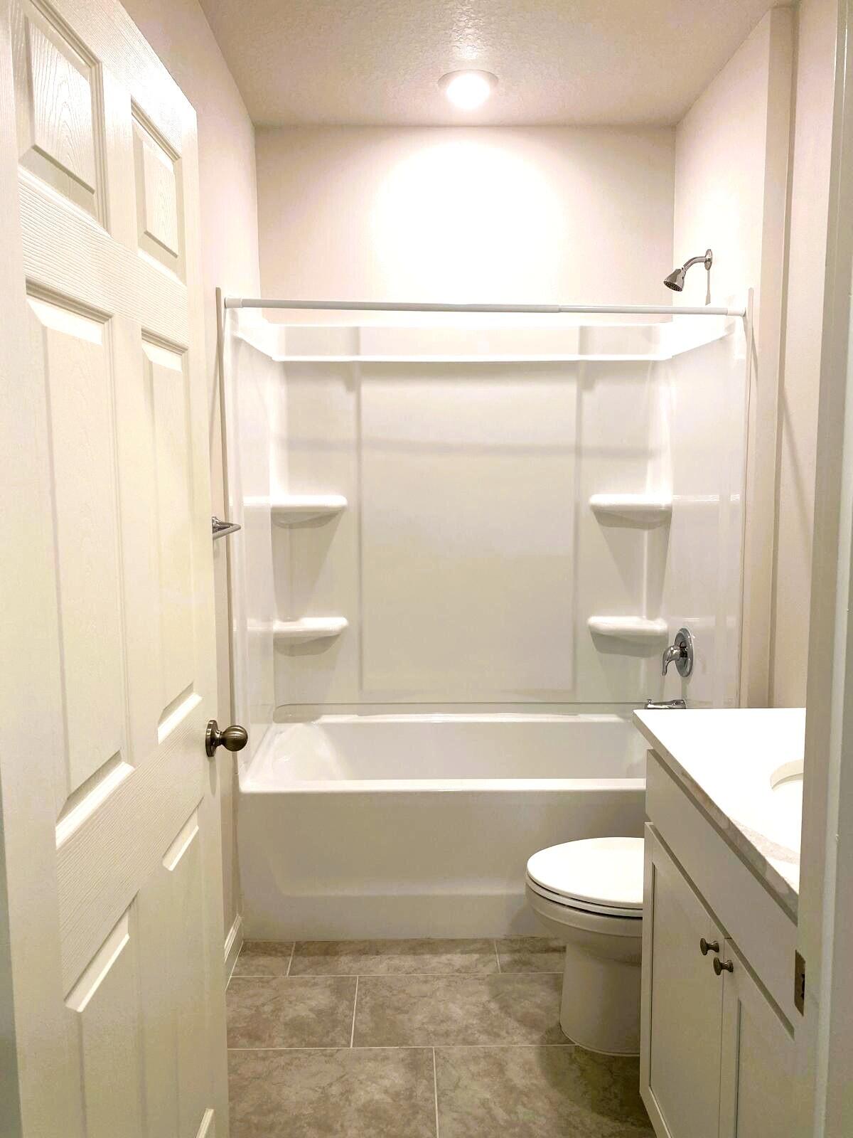 9622 Seaspray Drive Fort Pierce, FL 34945 - Photo 20 of 32 a bathroom with a toilet a sink and bathtub