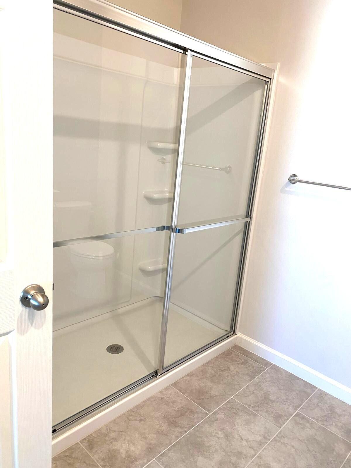 9622 Seaspray Drive Fort Pierce, FL 34945 - Photo 22 of 32 a bathroom with a glass shower door