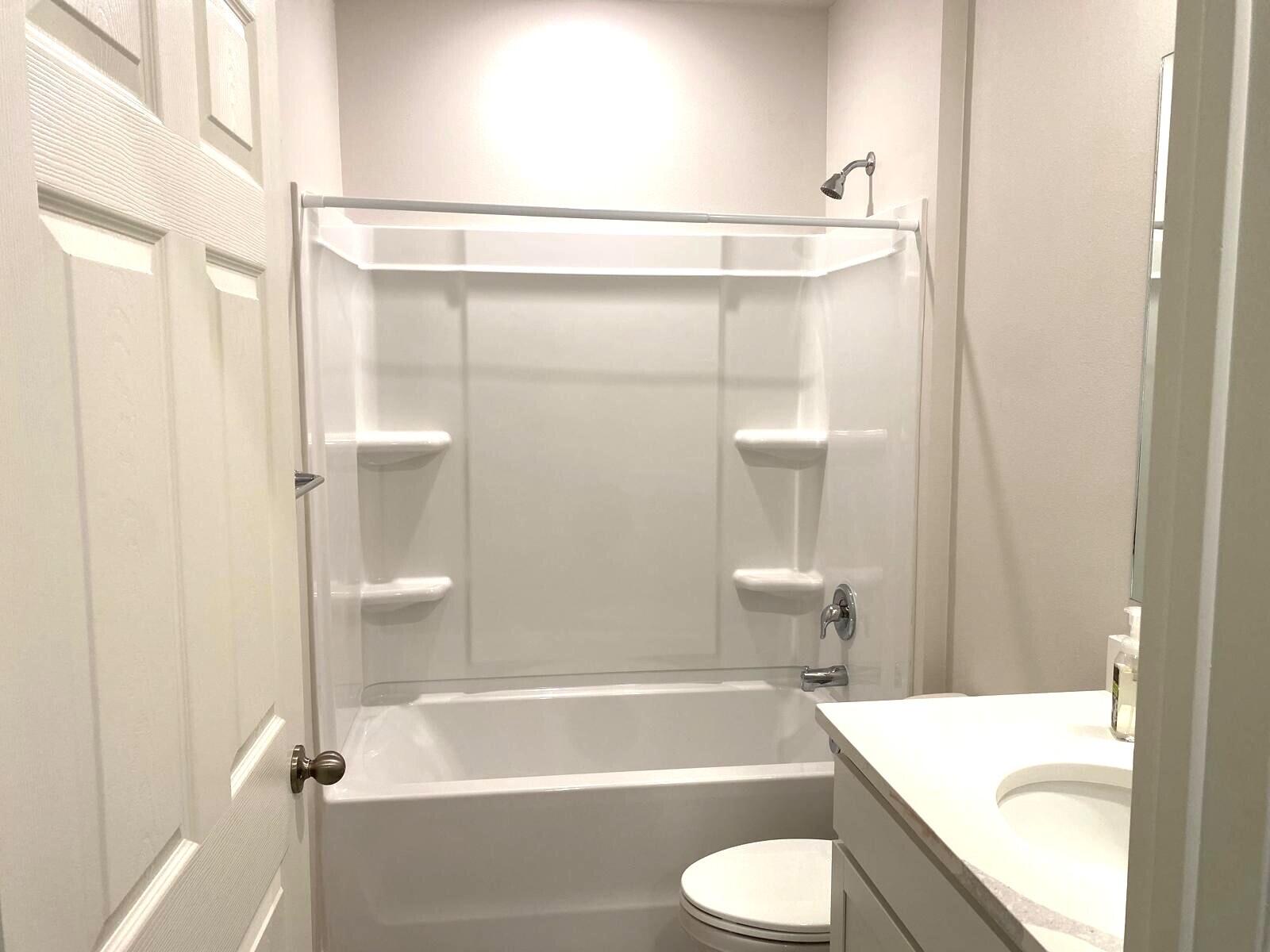 9622 Seaspray Drive Fort Pierce, FL 34945 - Photo 24 of 32 a bathroom with a sink toilet and shower