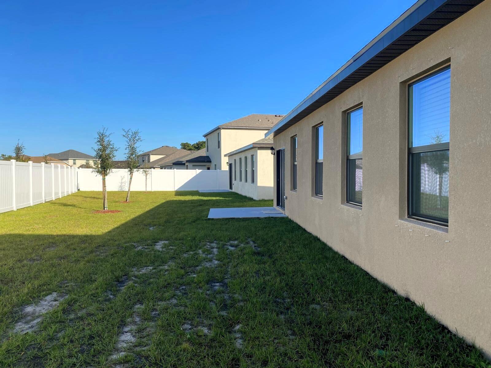 9622 Seaspray Drive Fort Pierce, FL 34945 - Photo 29 of 32 a view of an house with backyard and a tree
