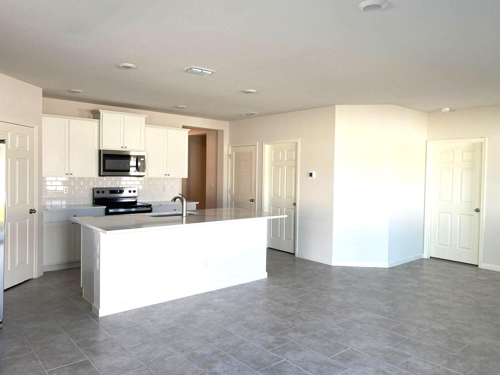 9622 Seaspray Drive Fort Pierce, FL 34945 - Photo 7 of 32 a large white kitchen