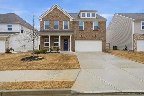 a front view of a house with a yard