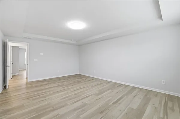 a view of an empty room and wooden floor