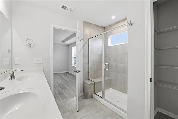 a bathroom with a shower and a sink
