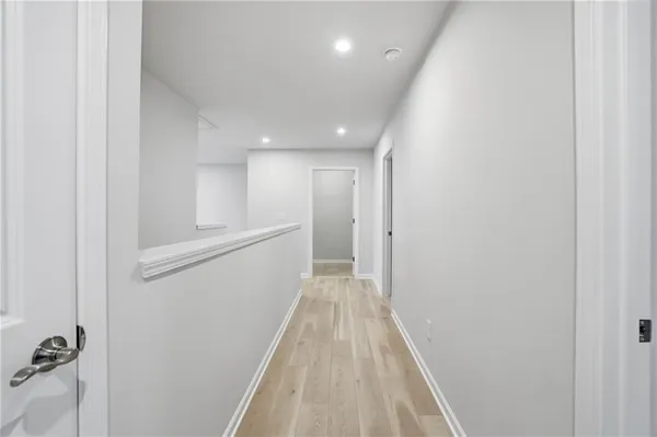 a view of a hallway with wooden floor