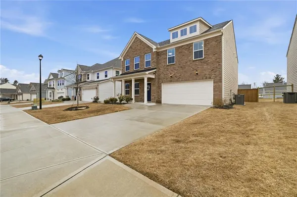 a front view of a building with streets and trees