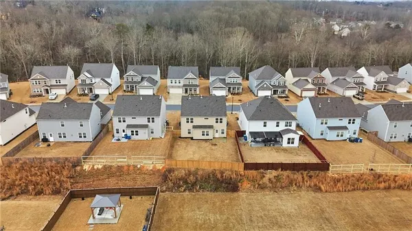 an aerial view of a house with a yard basket ball court