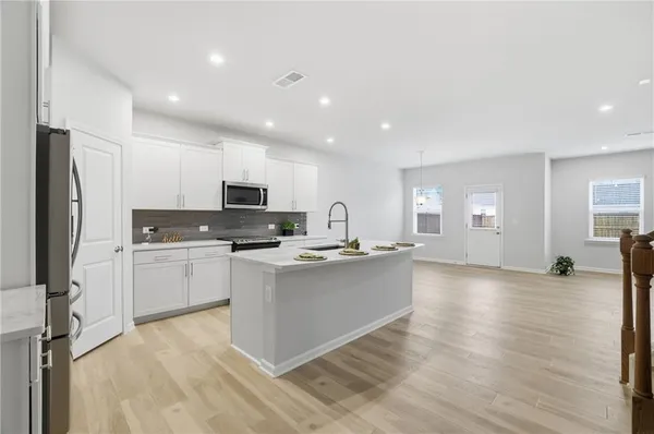 a kitchen with a sink stainless steel appliances and cabinets
