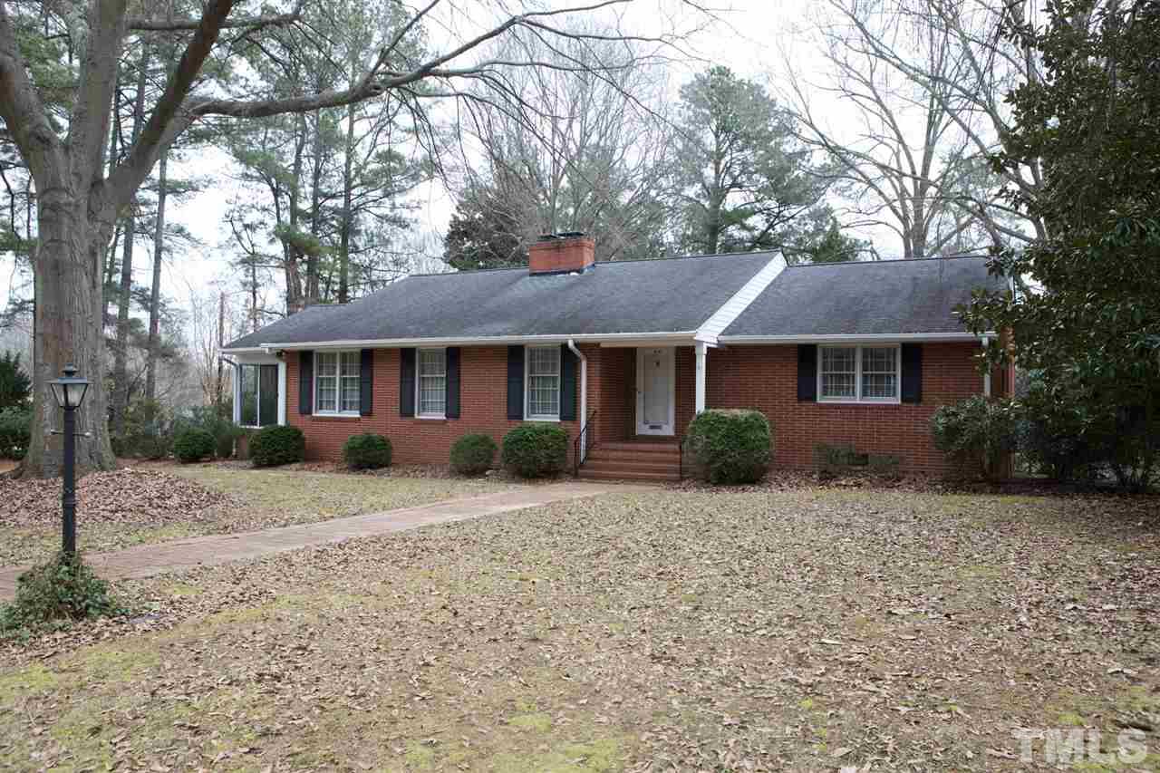 314 Cates Street Roxboro, NC 27573 - Photo 1 of 19 a front view of a house with a garden