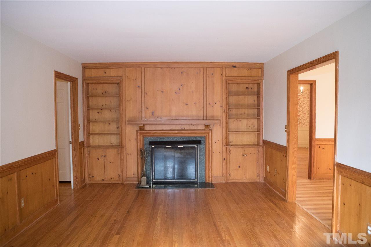 314 Cates Street Roxboro, NC 27573 - Photo 13 of 19 a view of empty room with wooden floor and fireplace