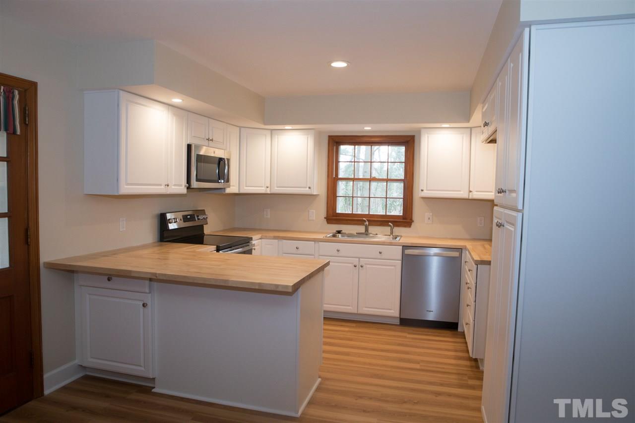 314 Cates Street Roxboro, NC 27573 - Photo 14 of 19 a kitchen with stainless steel appliances granite countertop a sink stove and refrigerator
