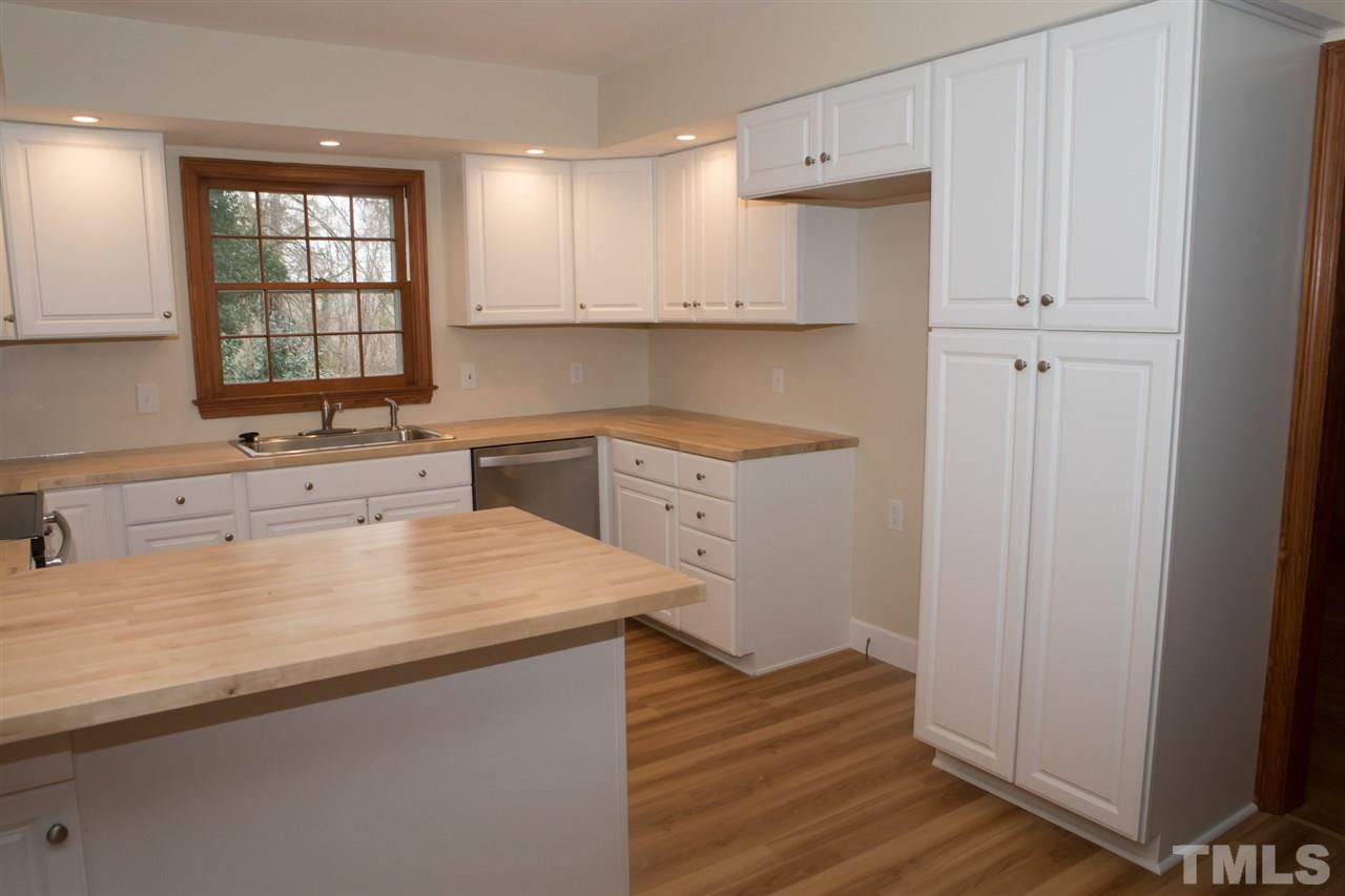 314 Cates Street Roxboro, NC 27573 - Photo 15 of 19 a kitchen with a sink stove and cabinets