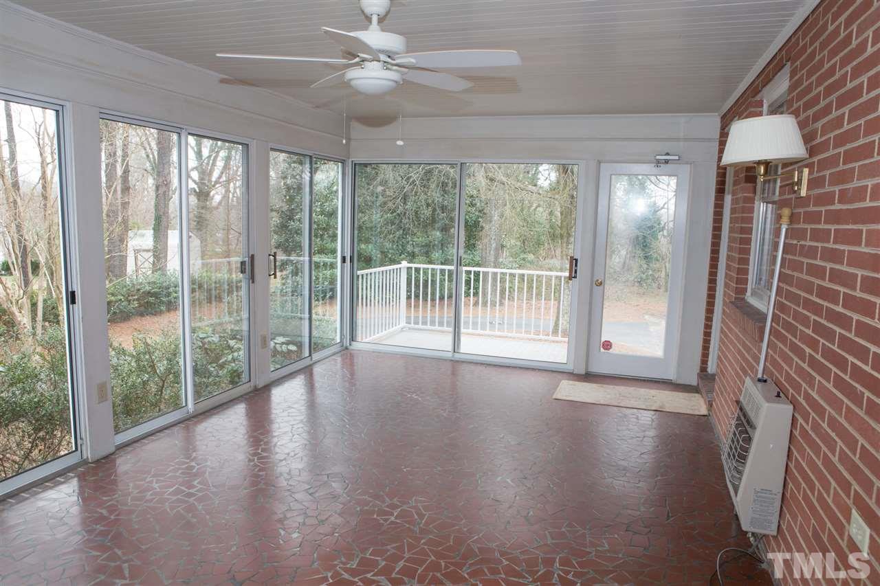 314 Cates Street Roxboro, NC 27573 - Photo 16 of 19 an empty room with wooden floor and windows