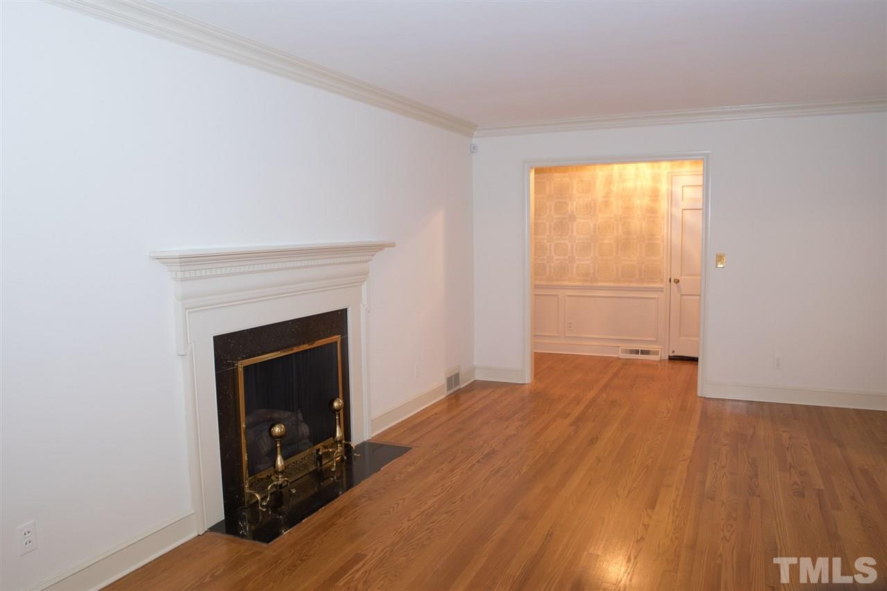 314 Cates Street Roxboro, NC 27573 - Photo 5 of 19 a view of an empty room with wooden floor and a fireplace
