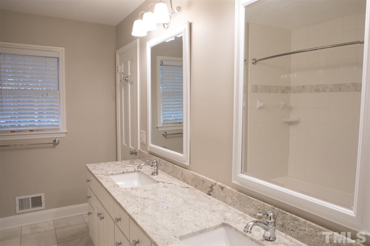 314 Cates Street Roxboro, NC 27573 - Photo 7 of 19 a bathroom with a granite countertop sink and a mirror