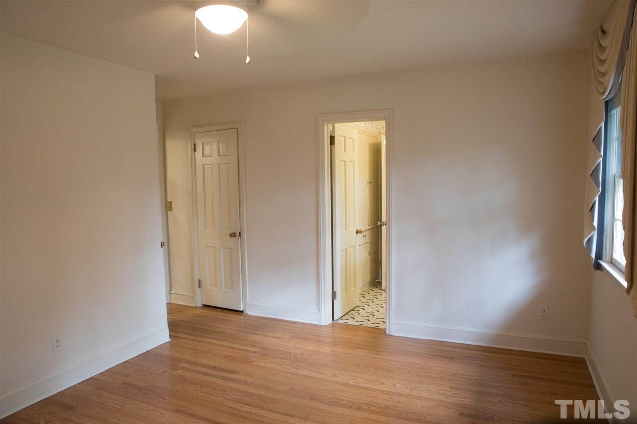 314 Cates Street Roxboro, NC 27573 - Photo 8 of 19 a view of an empty room with wooden floor and a window