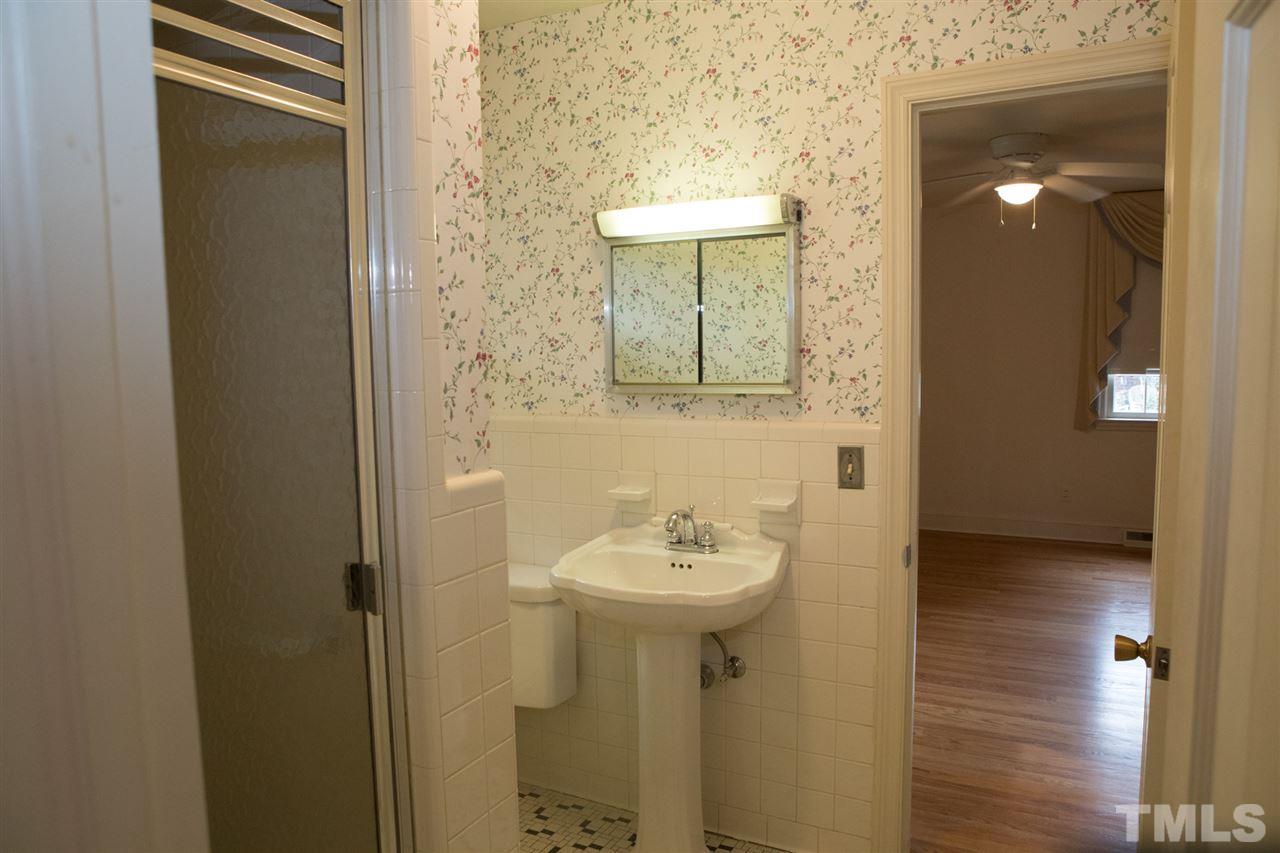 314 Cates Street Roxboro, NC 27573 - Photo 9 of 19 a bathroom with a sink a mirror and shower