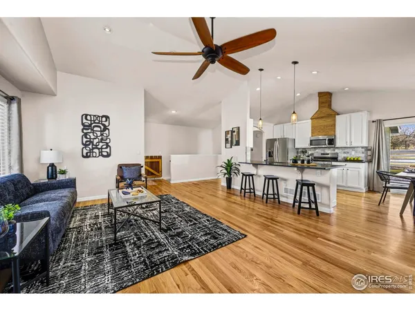 a living room with furniture and kitchen view