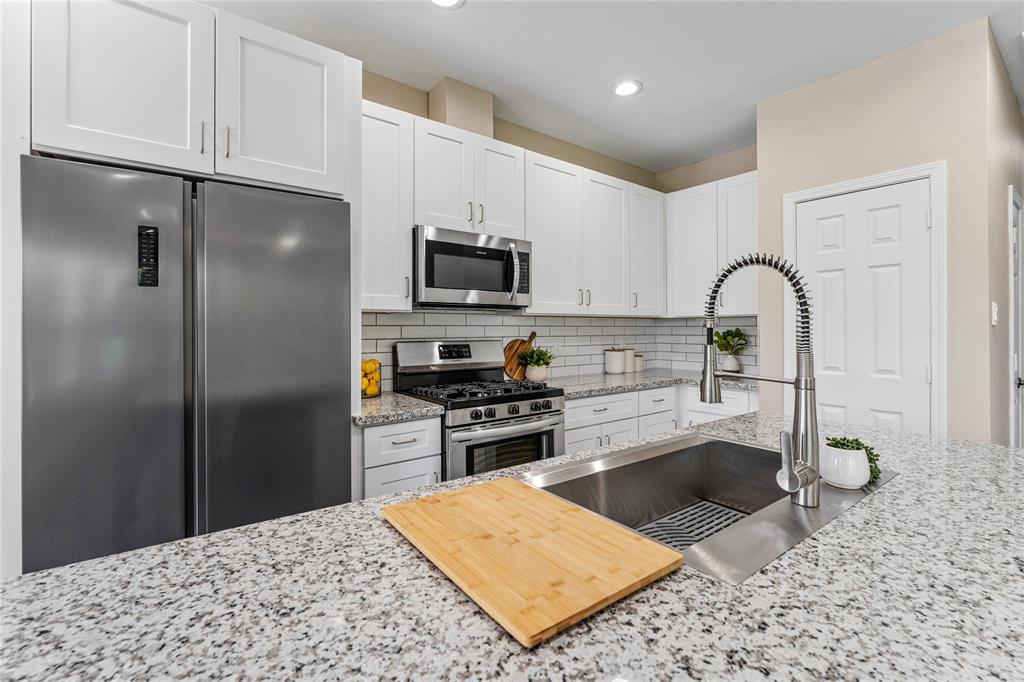 10321 Teneha Drive, Unit A Houston, TX 77033 - Photo 1 of 31 a kitchen with stainless steel appliances granite countertop a refrigerator a stove a sink a washer and dryer