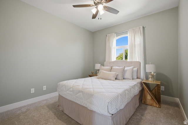 1252 Skyline Road Saratoga Springs, UT 84045 - Photo 25 of 51 Carpeted room featuring a ceiling fan, arched window, and light gray walls with white baseboards