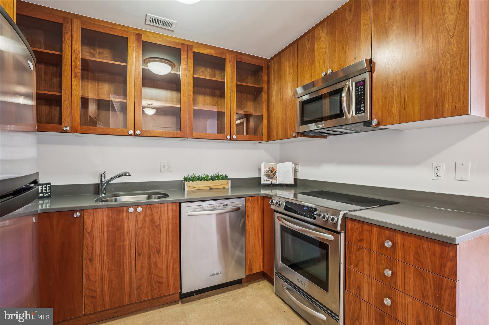 1803 T Street Northwest, Unit 3 Washington, DC 20009 - Photo 15 of 45 a kitchen with stainless steel appliances granite countertop a stove and a microwave
