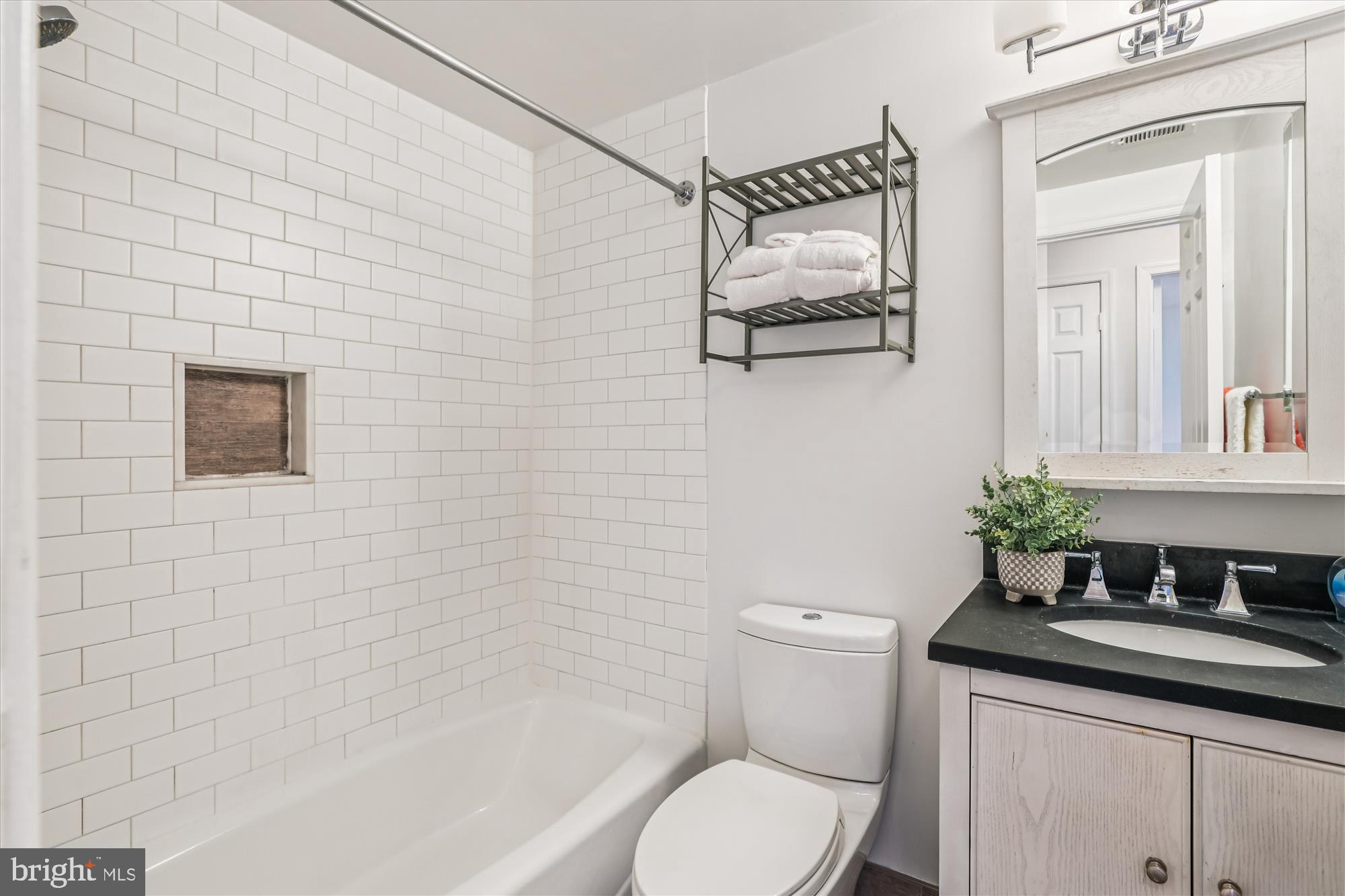 1803 T Street Northwest, Unit 3 Washington, DC 20009 - Photo 20 of 45 a bathroom with a granite countertop toilet sink and mirror