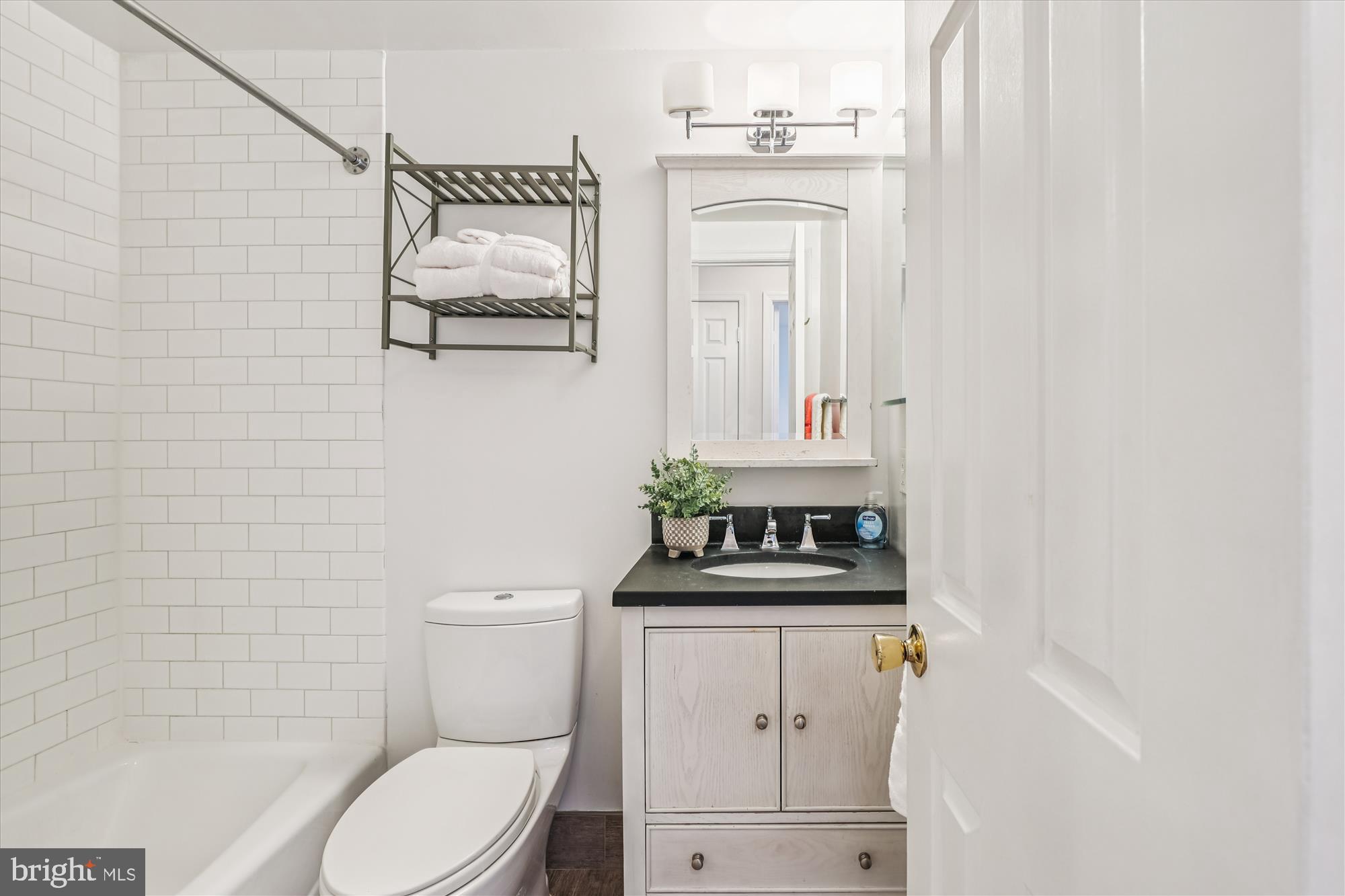 1803 T Street Northwest, Unit 3 Washington, DC 20009 - Photo 21 of 45 a bathroom with a toilet a sink and mirror