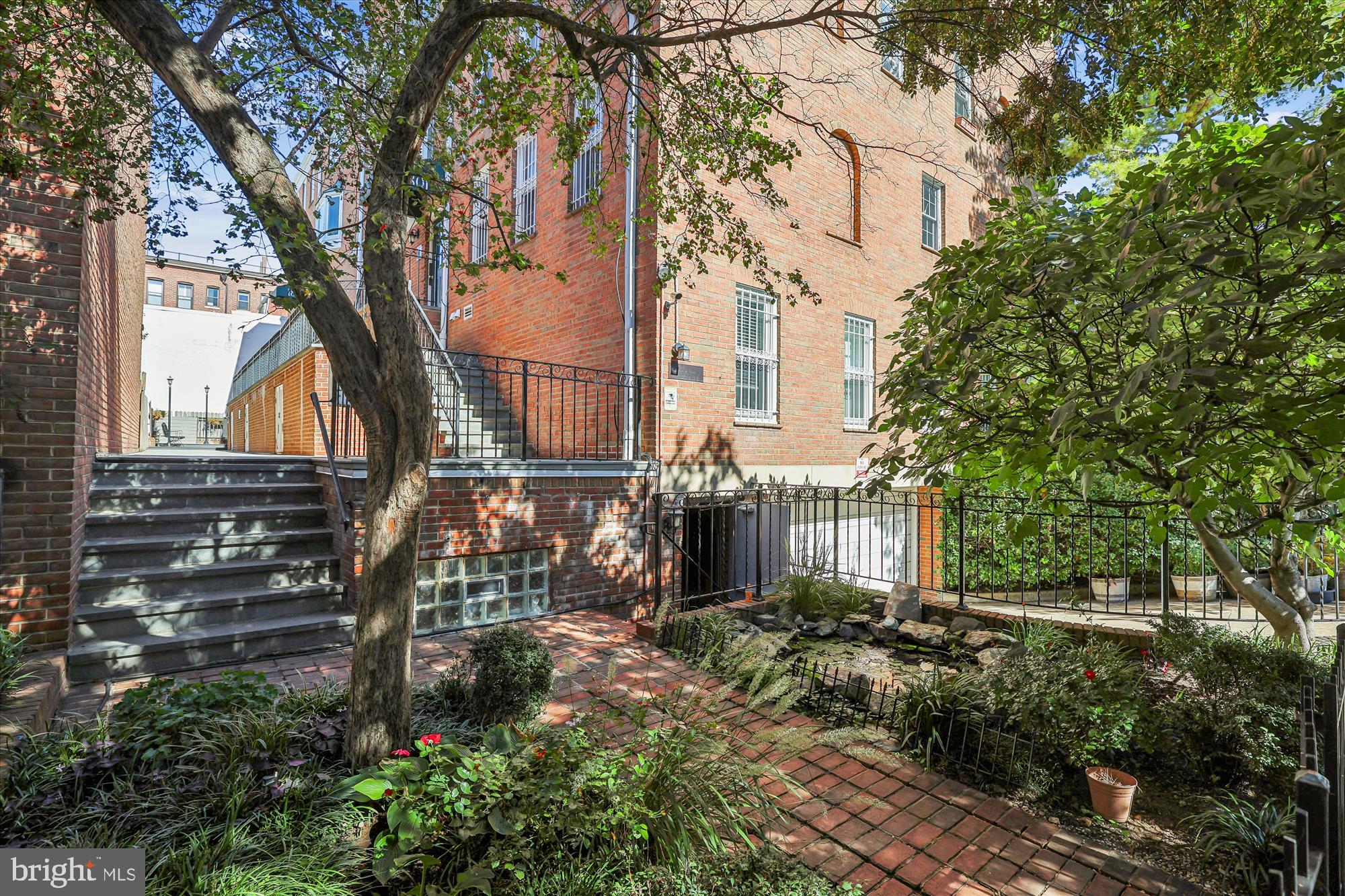 1803 T Street Northwest, Unit 3 Washington, DC 20009 - Photo 5 of 45 a view of a house with a tree and wooden fence