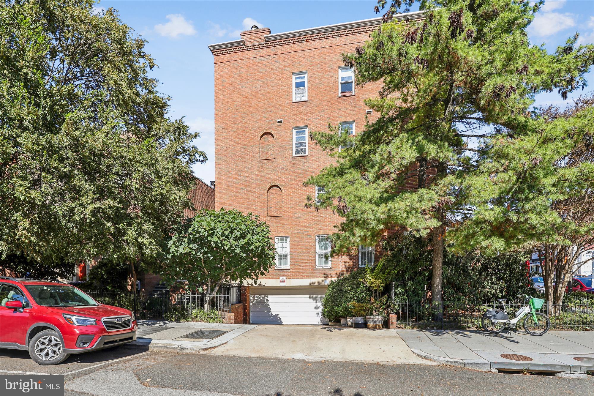1803 T Street Northwest, Unit 3 Washington, DC 20009 - Photo 6 of 45 a front view of a house with a yard and garage