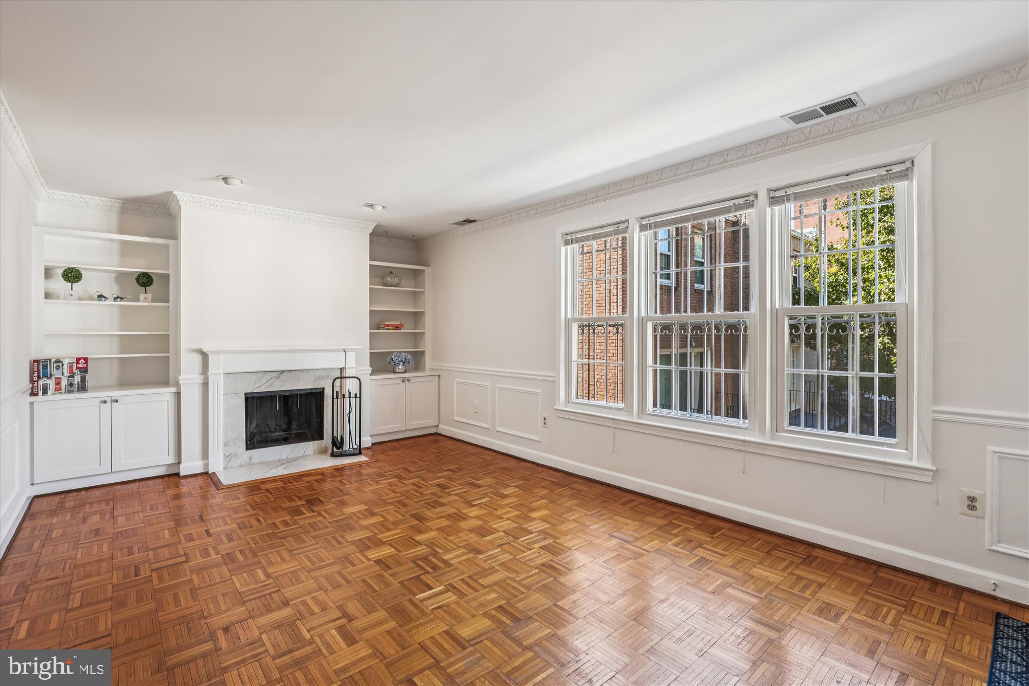 1803 T Street Northwest, Unit 3 Washington, DC 20009 - Photo 10 of 45 a view of an empty room with a fireplace and a window