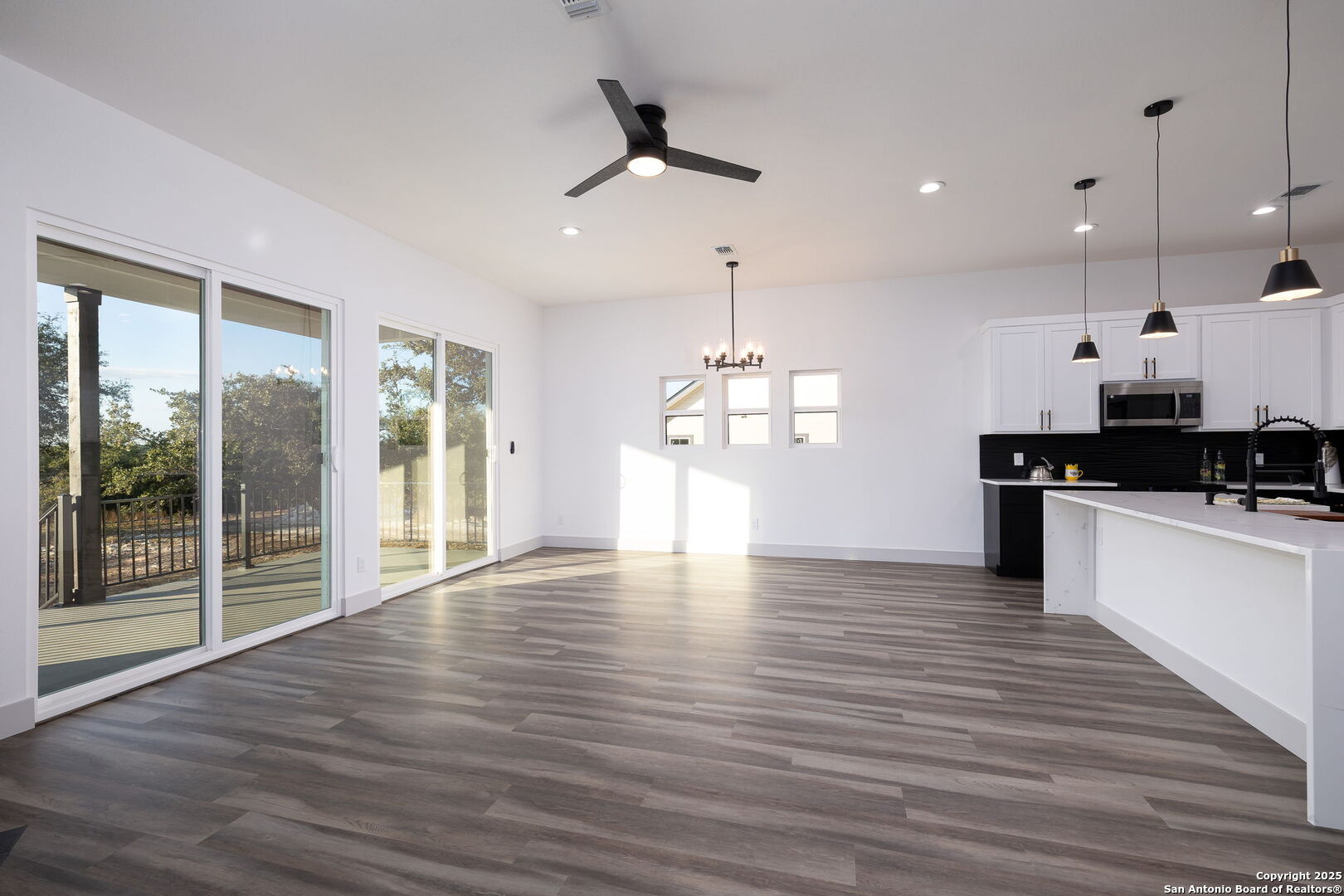 1210 Fernwood Road Fischer, TX 78623 - Photo 12 of 36 a view of an empty room with wooden floor and a window