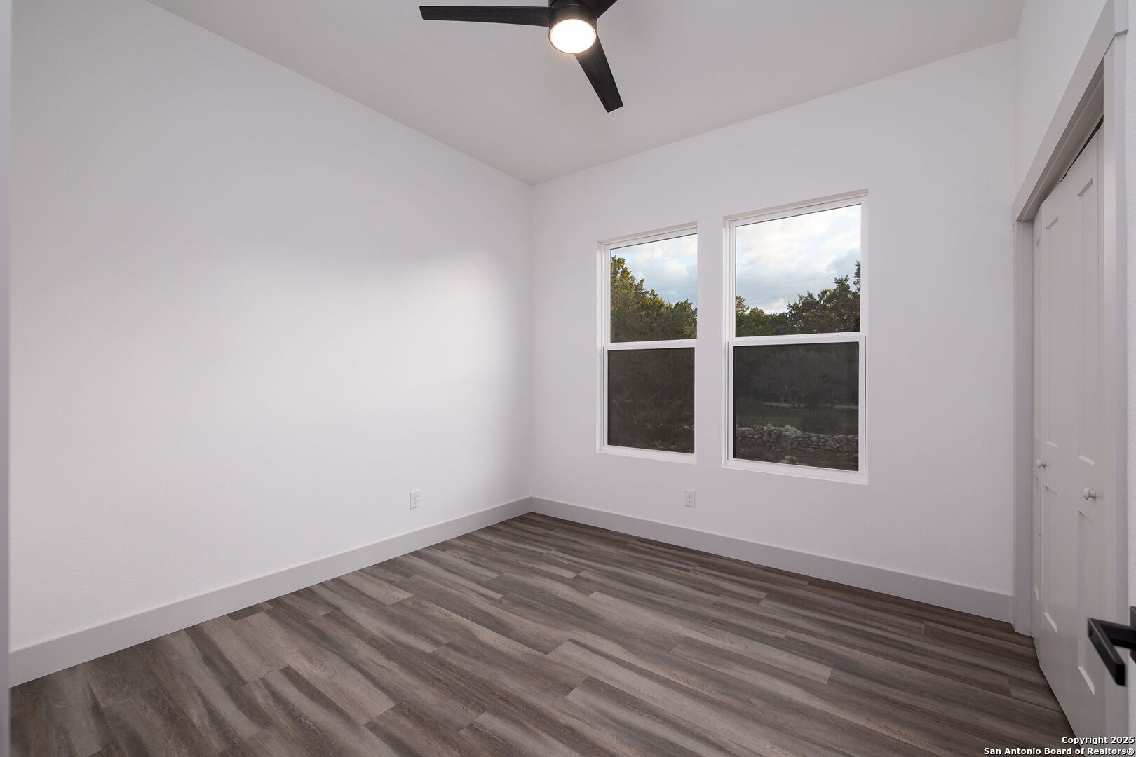 1210 Fernwood Road Fischer, TX 78623 - Photo 28 of 36 an empty room with wooden floor and windows