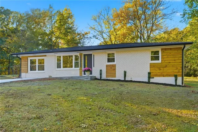a house that has a tree in front of it