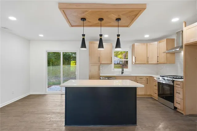 a kitchen with stainless steel appliances granite countertop a sink stove and refrigerator