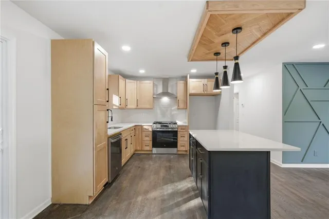 a kitchen with stainless steel appliances a sink stove and refrigerator