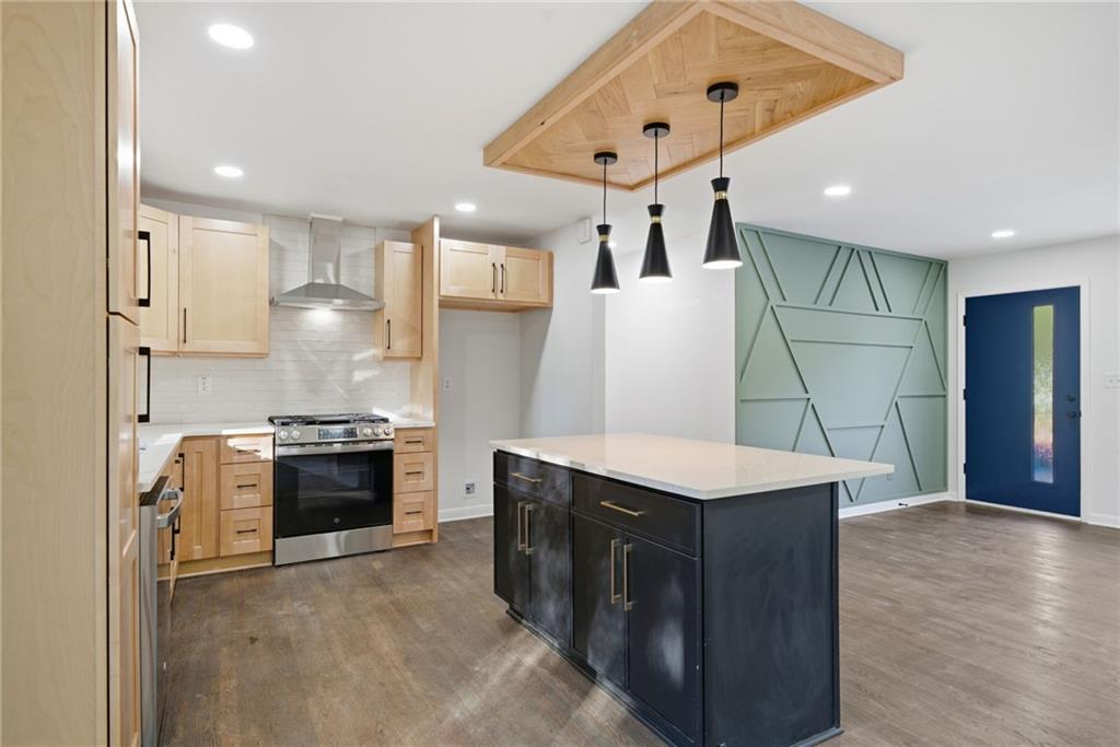 6807 Tralee Drive Lithia Springs, GA 30122 - Photo 16 of 36 a kitchen with granite countertop a refrigerator stove top oven and sink