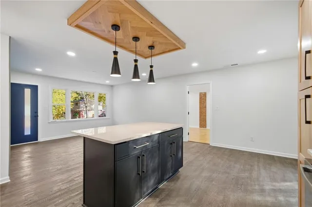 a kitchen with a sink chandelier and refrigerator