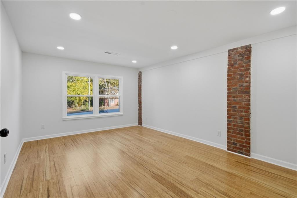 6807 Tralee Drive Lithia Springs, GA 30122 - Photo 20 of 36 wooden floor in an empty room with a window