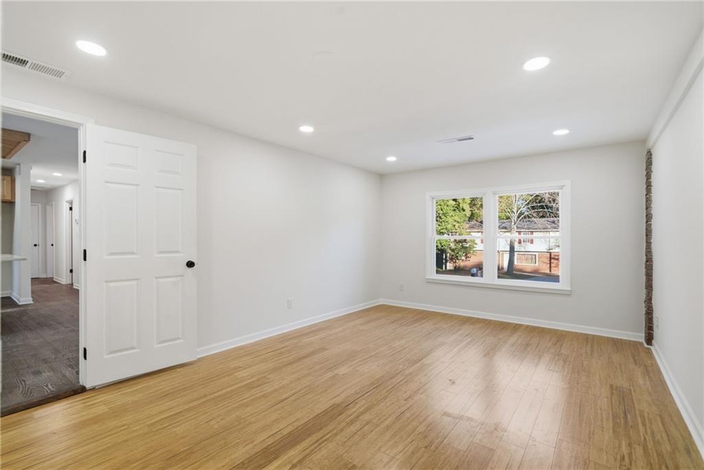 6807 Tralee Drive Lithia Springs, GA 30122 - Photo 21 of 36 an empty room with wooden floor and window