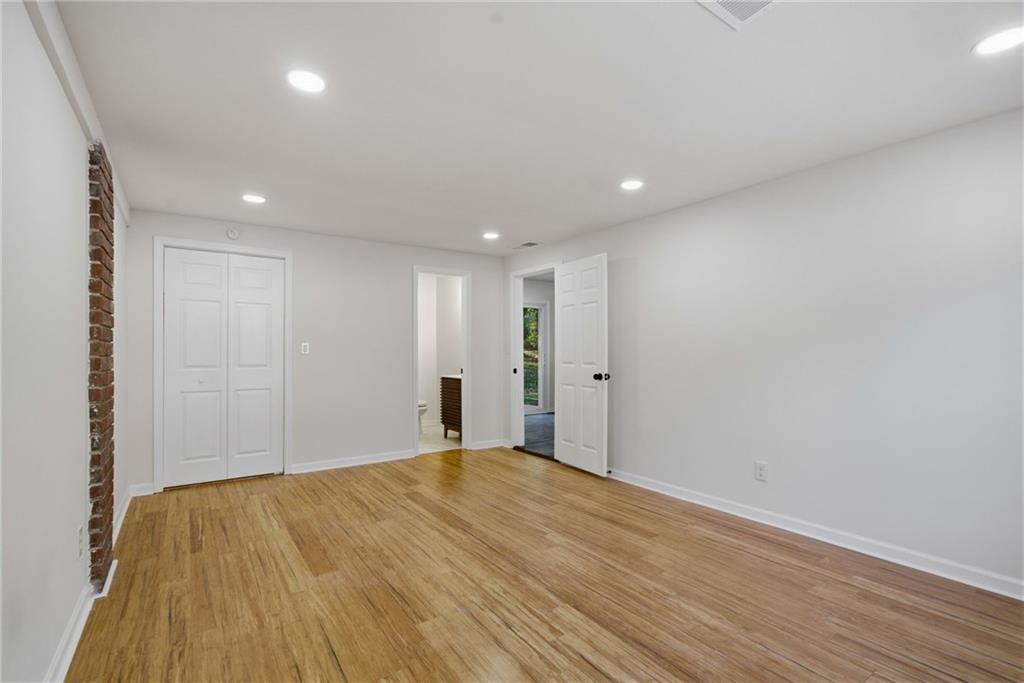 6807 Tralee Drive Lithia Springs, GA 30122 - Photo 22 of 36 a view of empty room with wooden floor
